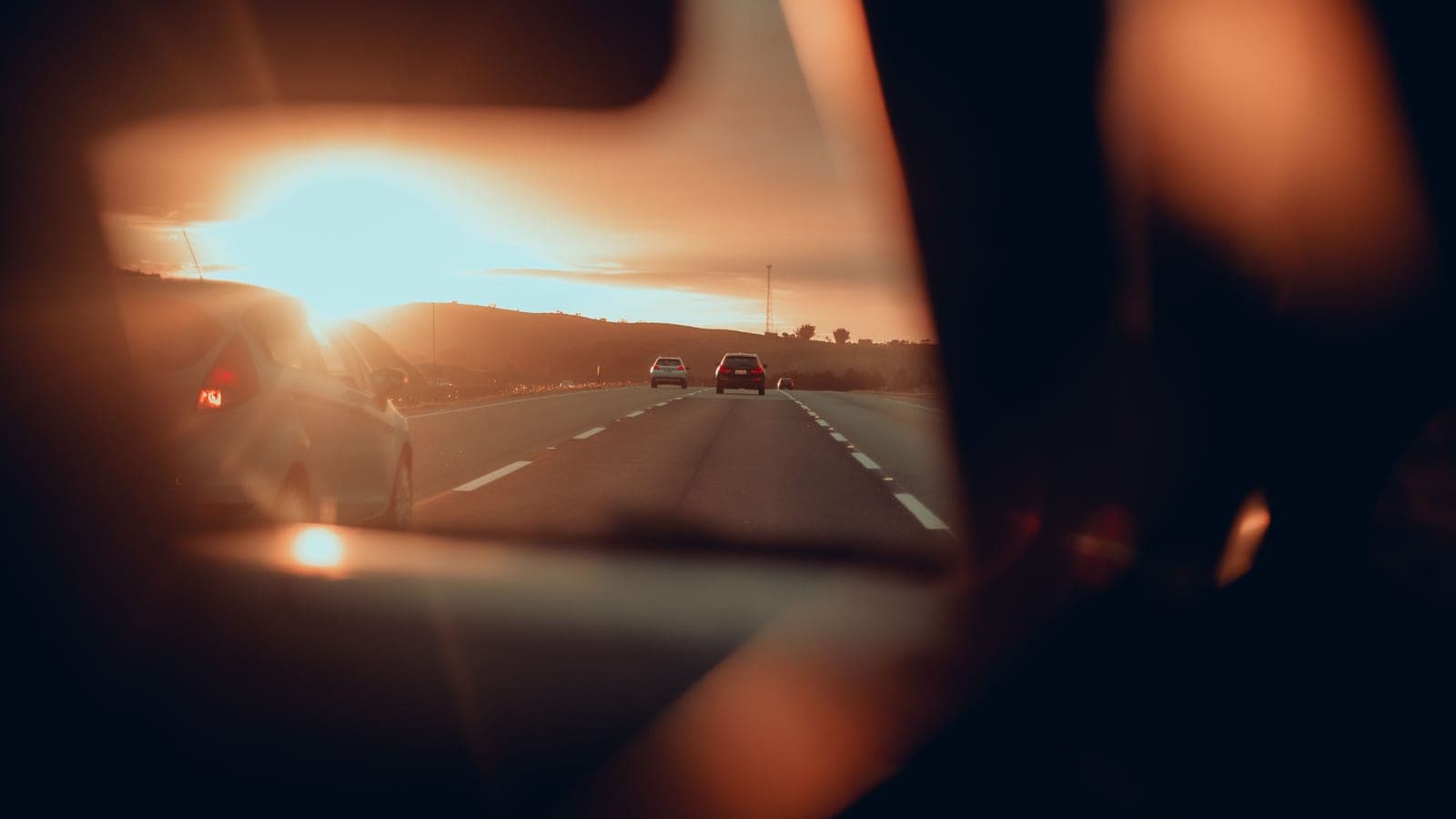 View through a car windshield on a sunny road on a bright day