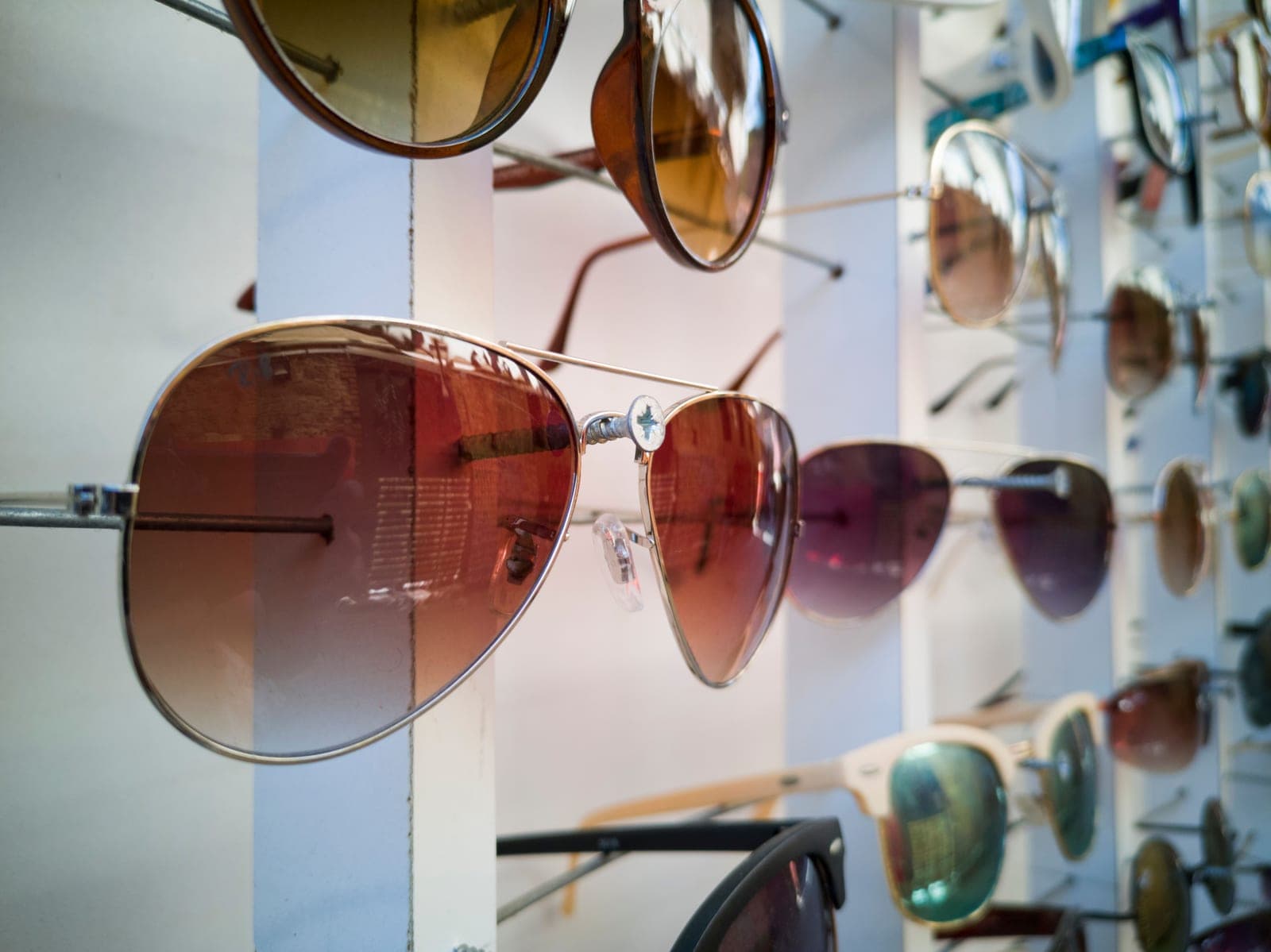 An assortment of sunglasses frames arranged on a bright surface