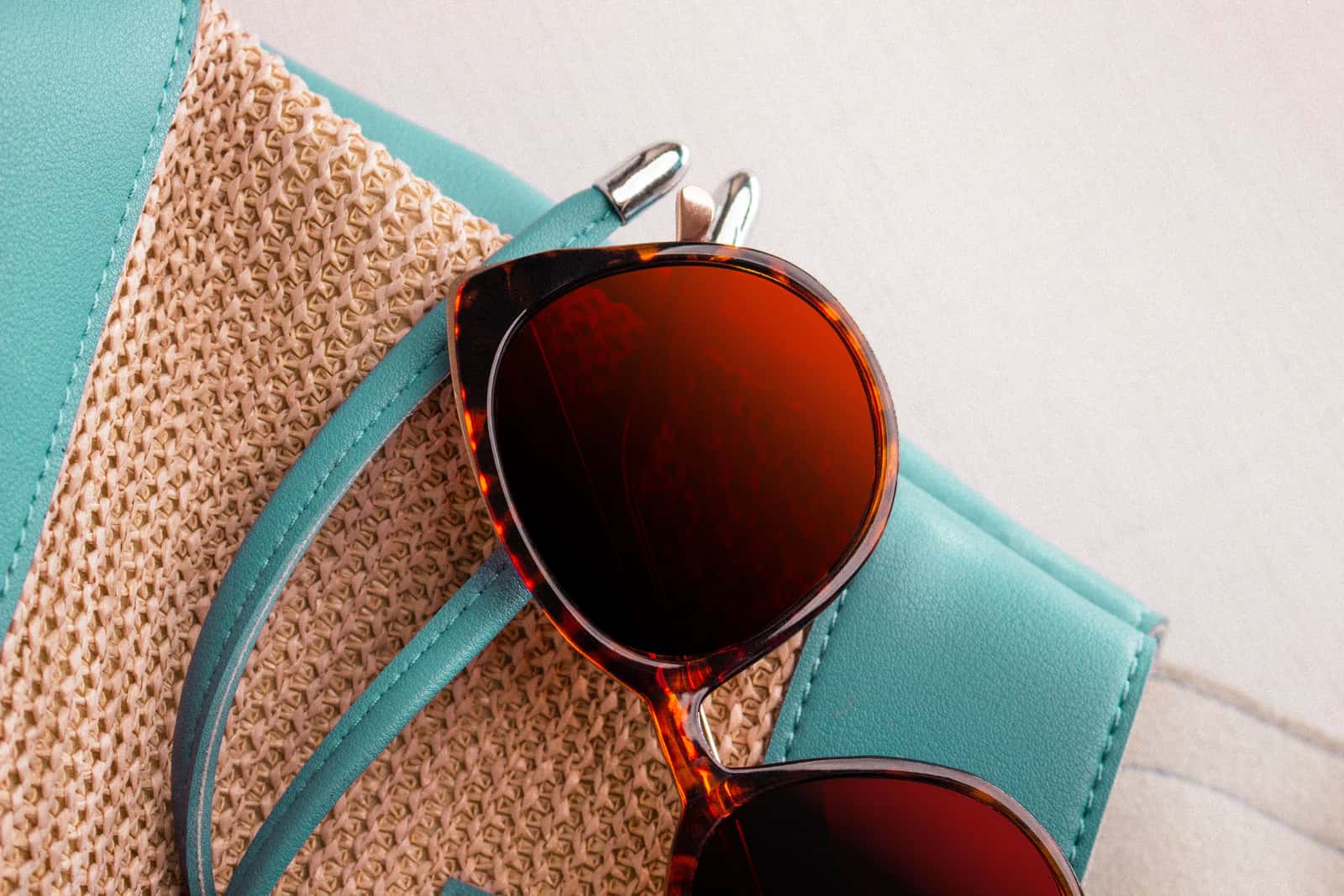 A close-up of a pair of sunglasses catching bright daylight
