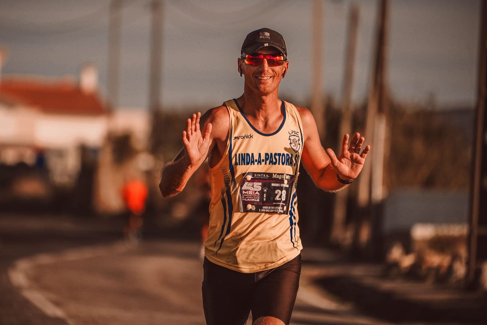 A runner on a sunlit trail wearing lightweight sport sunglasses